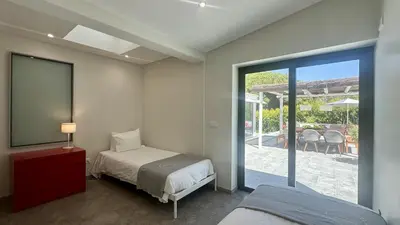 a bedroom with a bed and a sliding glass door at Tropicana by Check-in Portugal in Albufeira