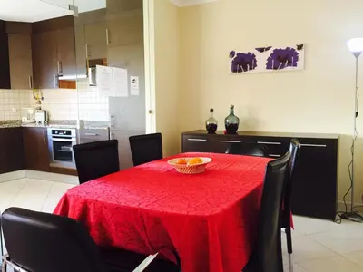 a dining room with a table with a red table cloth at Albufeira Luxury Villa in Albufeira
