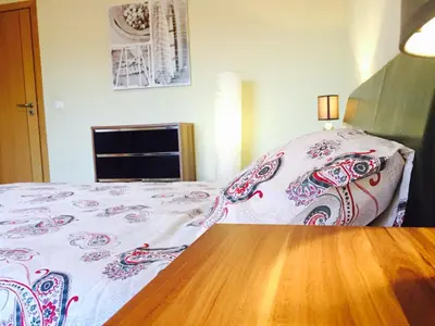 a bedroom with a bed and a wooden floor at Albufeira Luxury Villa in Albufeira