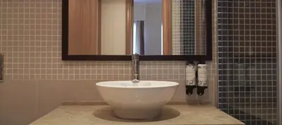 a sink in a bathroom with a mirror at VILAMOURA - The Residences in Quarteira