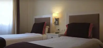 a hotel room with two beds and a window at VILAMOURA - The Residences in Quarteira