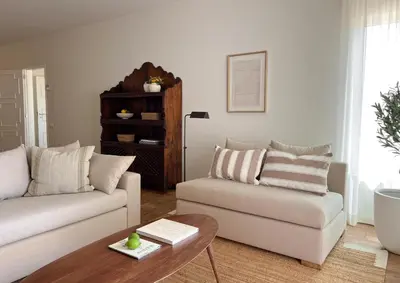 a living room with a couch and a coffee table at Vila Antic in Almancil