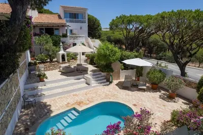 an external view of a house with a swimming pool at Vila Antic in Almancil