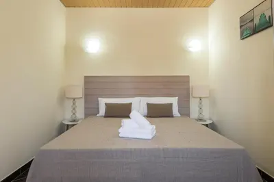 a bedroom with a large bed with two white pillows at Casa Do Vale - Algarve in Vargem da Mão