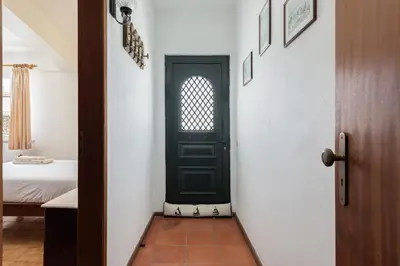 a green door in a room with a bedroom at Vila Coelho - City center with pool by HD in Vale de Pedras