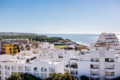 an aerial view of white buildings and the ocean at Mar Azul 2 Bdr Apartment Quarteira in Quarteira