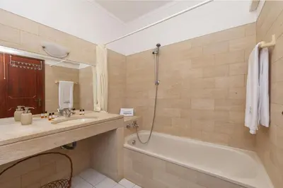 a bathroom with a tub and a sink and a shower at A02 - Casa Topazio in Quarteira in Quarteira