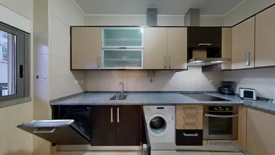 a kitchen with a sink and a washing machine at Apartamento T0 MFA, 400m Praia dos Pescadores in Albufeira