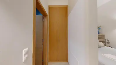 a hallway with a wooden door in a bedroom at Apartamento T0 MFA, 400m Praia dos Pescadores in Albufeira