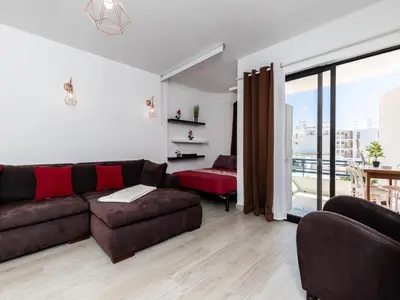 a living room with a couch and a large window at Akisol Albufeira Getaway in Olhos de Água