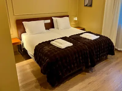 a bedroom with a large bed with two towels on it at Fly House Faro in Faro