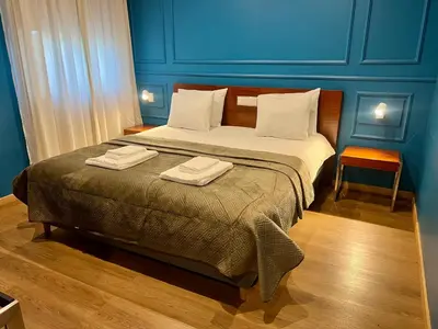 a bedroom with a bed with two towels on it at Fly House Faro in Faro