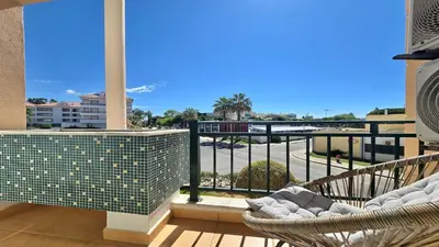 a balcony with two chairs and a view of a street at Marina Sol - CD 308, Cleverdetails - great location in Vilamoura