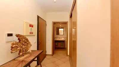 a hallway with a wooden bench in a room at Marina Sol - CD 308, Cleverdetails - great location in Vilamoura