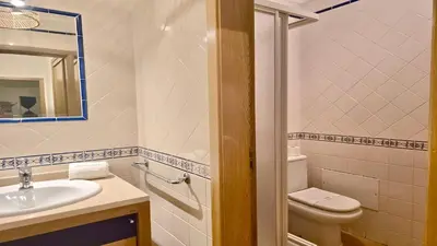 a bathroom with a sink and a toilet and a mirror at Marina Sol - CD 308, Cleverdetails - great location in Vilamoura