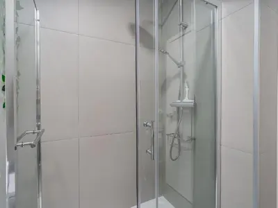 a shower with a glass door in a bathroom at Algarsol 1bdr apartment near the beach in Quarteira