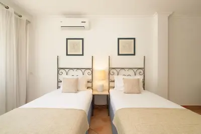 two beds sitting next to each other in a bedroom at Charming Villa with Private Pool by LovelyStay in Albufeira