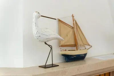a plastic bird standing on a shelf next to a toy boat at Charming Villa with Private Pool by LovelyStay in Albufeira