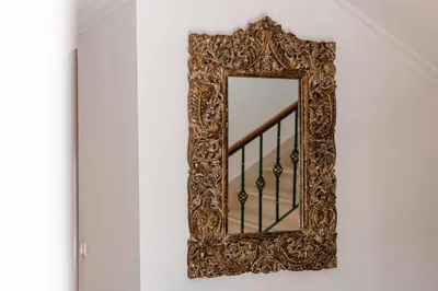 a mirror on a wall next to a staircase at Charming Villa with Private Pool by LovelyStay in Albufeira