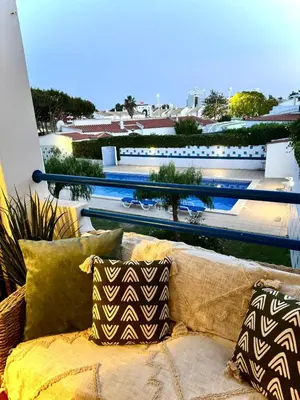 a couch on a balcony with a view of the ocean at Oura beach & sun in Albufeira
