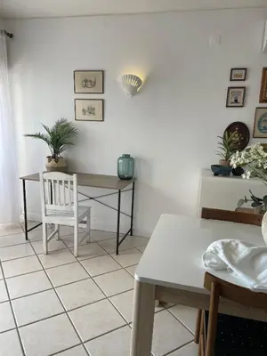 a dining room with a table and a chair at Oura beach & sun in Albufeira