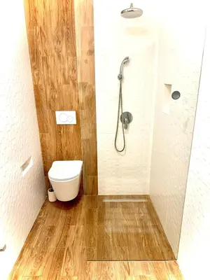 a bathroom with a shower and a toilet at Oura beach & sun in Albufeira