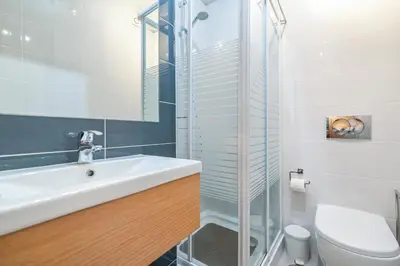 a bathroom with a sink and a toilet at Vitismar GroundFloor Apartment with Direct Pool Access in Albufeira in Guia