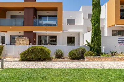 a house in the suburbs with a yard at Vitismar GroundFloor Apartment with Direct Pool Access in Albufeira in Guia