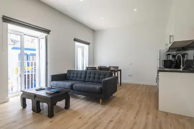 a living room with a couch and a table at Downtown 1 Bedroom Apartment E - 150m from the Beach in Albufeira