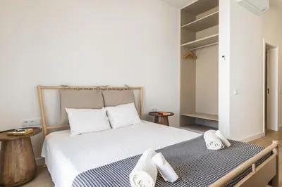 a bedroom with a bed with two towels on it at Downtown Studio Apartment F - 150m from the Beach in Albufeira
