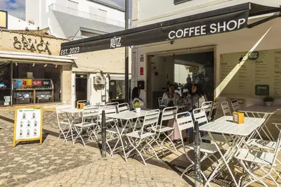 a group of tables and chairs outside of a coffee shop at Downtown Studio Apartment F - 150m from the Beach in Albufeira