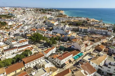 an aerial view of a city with buildings and the ocean at Downtown Studio Apartment F - 150m from the Beach in Albufeira