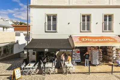 a group of people standing in front of a store at Downtown Studio Apartment G - 150m from the Beach in Albufeira