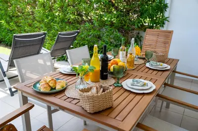 a wooden table with food and bottles of wine at Sunset Villa No 19 in Galé