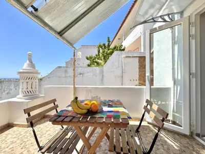 a table with bananas and fruit on a balcony at Albufeira Amazing View With Pool by Homing in Albufeira