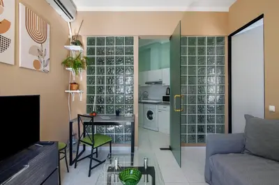 a living room with a couch and a table at Faro Downtown Suites - Vila Adentro in Faro
