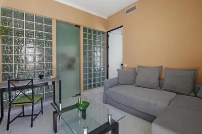 a living room with a couch and a table at Faro Downtown Suites - Vila Adentro in Faro