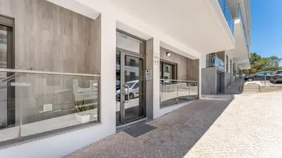 a facade of a building with glass doors at Elegant 2BDR Apartment in Quarteira by Lovelystay in Quarteira