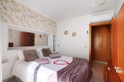 a bedroom with a bed with a red ribbon on it at Casa Vista Mar in Albufeira