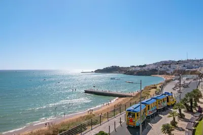a train on a beach next to the ocean at Casa Vista Mar in Albufeira