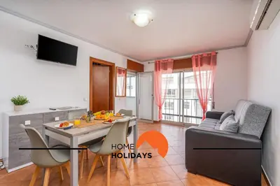 a living room with a table and a couch at #286 Avenida de Ceuta - Alsol by Home Holidays in Quarteira