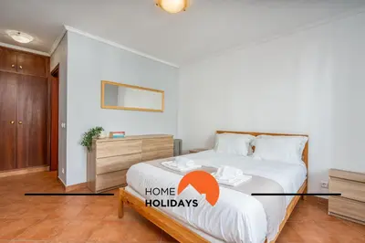a bedroom with a large bed with an orange arrow pointing to home holidays at #286 Avenida de Ceuta - Alsol by Home Holidays in Quarteira