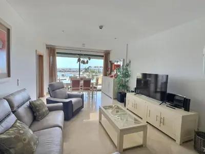 a living room with a couch and a flat screen tv at Marina Vilamoura - Aquamar 205 - 3 Quartos in Quarteira
