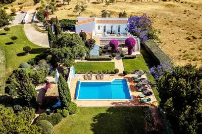 an aerial view of a house with a swimming pool at Lovely Very Private Villa with Beautiful Gardens in Guia