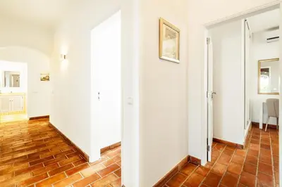 an empty hallway with white walls and wood floors at Lovely Very Private Villa with Beautiful Gardens in Guia