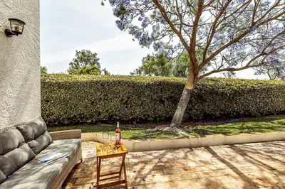 a living room with a couch and a tree at Lovely Very Private Villa with Beautiful Gardens in Guia