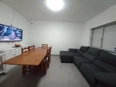 a kitchen with white cabinets and a sink at T2 Praia de Faro in Faro