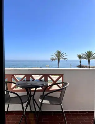 a table and chairs on a balcony with the ocean at Sunflower12 - Apartamento à beira-mar - Seaview in Quarteira