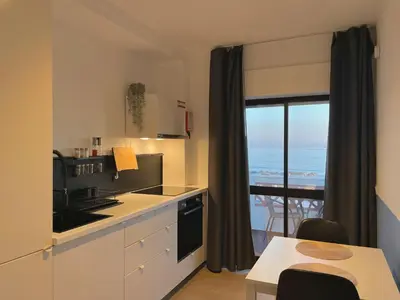 a kitchen with a view of the ocean at Sunflower12 - Apartamento à beira-mar - Seaview in Quarteira