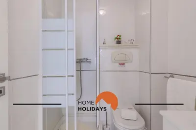 a bathroom with a toilet and a shower with the words home holidays at #320 Quinta da Correeira 55 by Home Holidays in Vale de Pedras